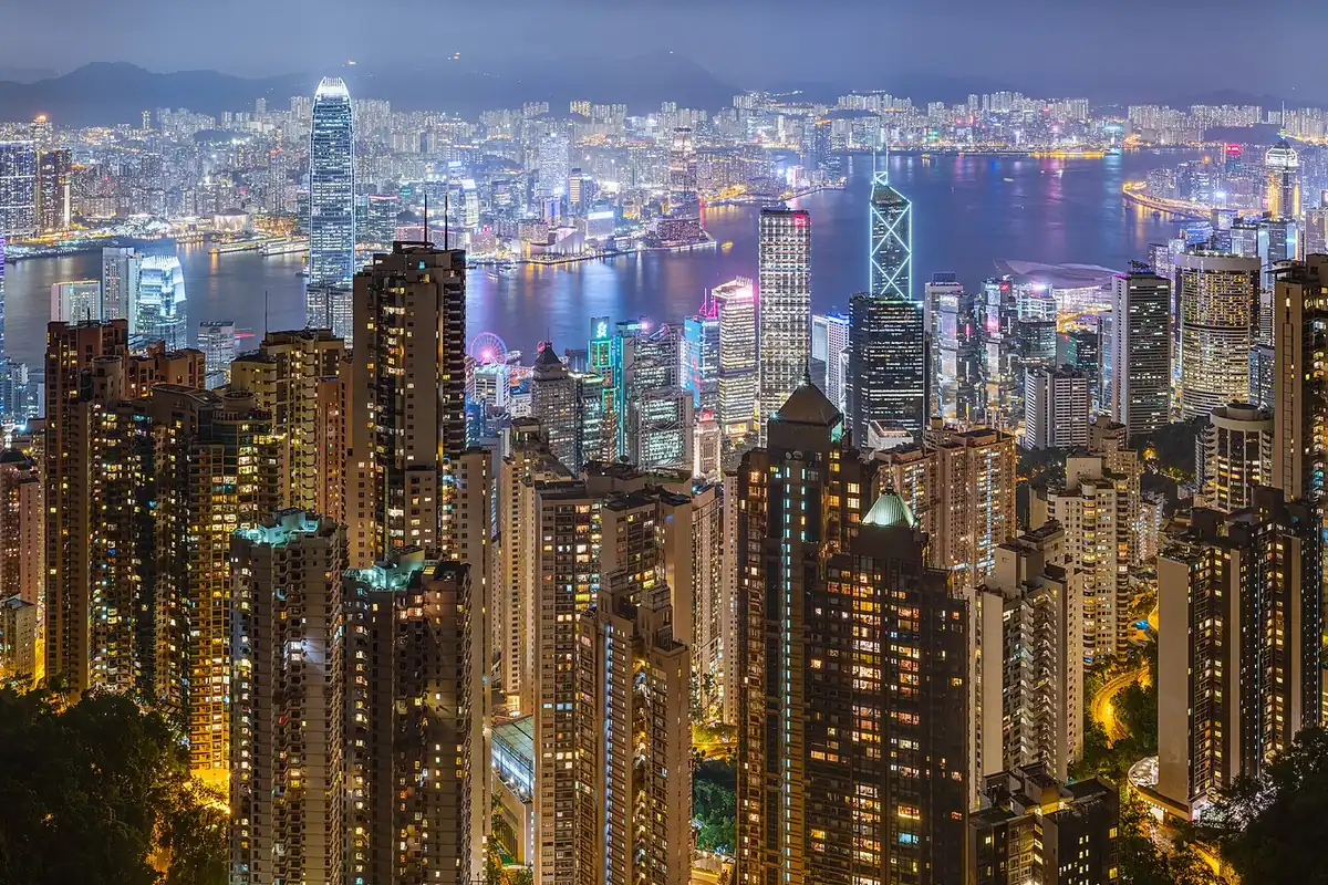 Victoria Harbour at night with the Hong Kong Island skyline lit across the water.